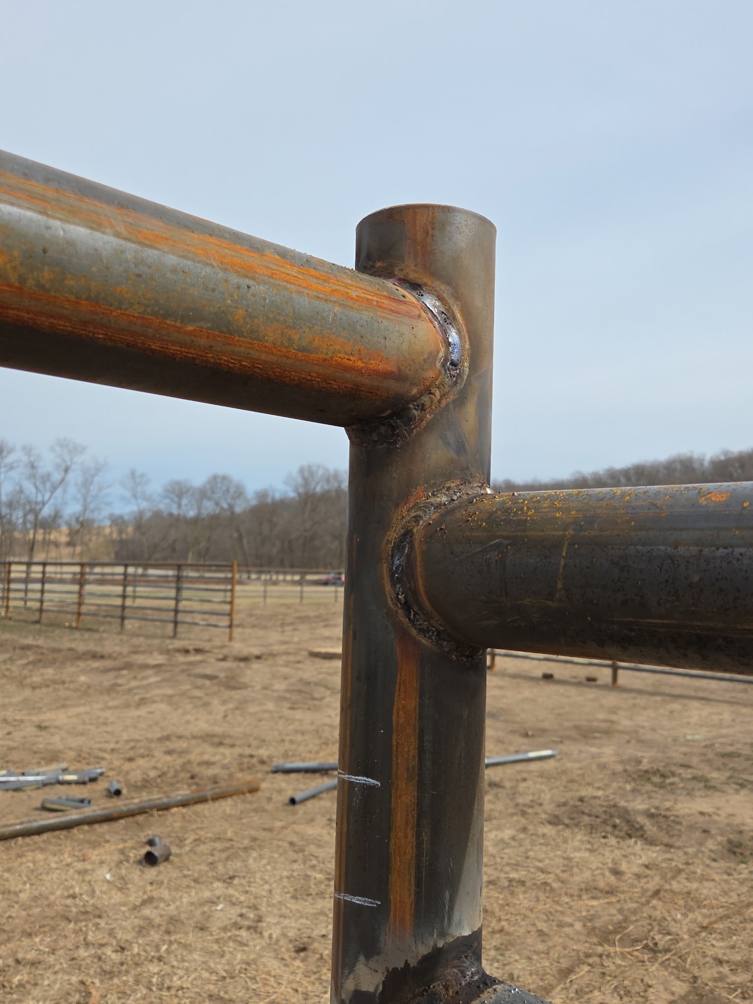Close-up of a clean pipe fence weld joint